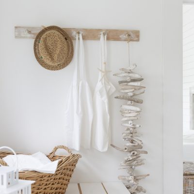 Driftwood and aprons hanging from beach house coat rack